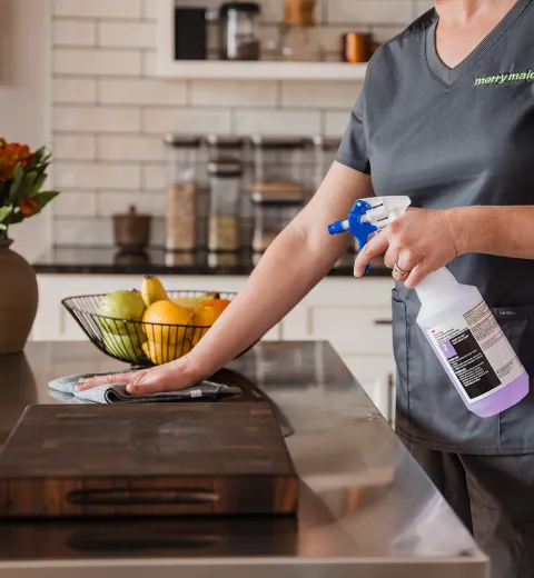 For that image, I'd go with: Merry Maids of York cleaning technician wiping down a kitchen countertop